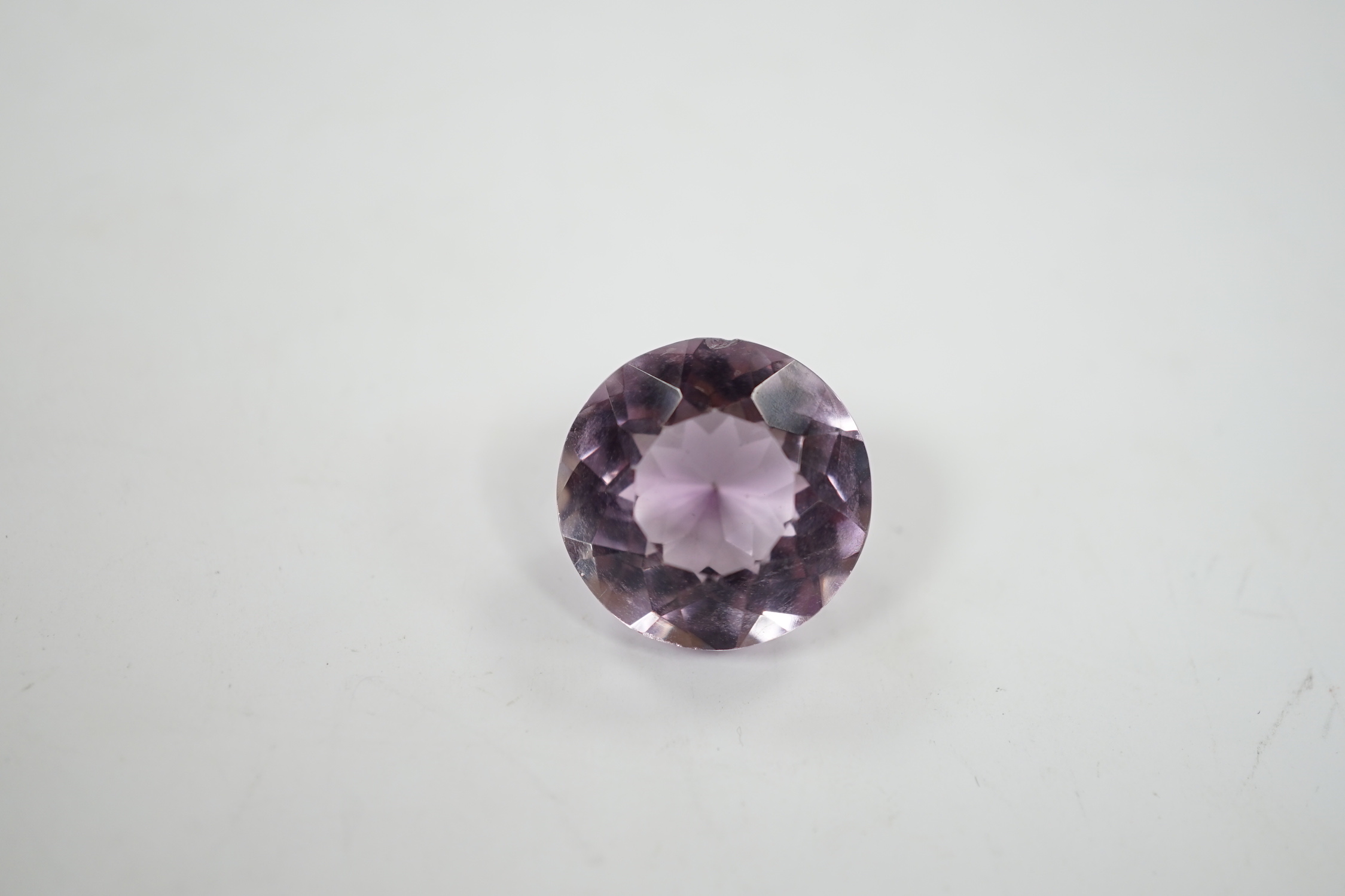 An unmounted round cut amethyst, weighing approximately 15.9ct.